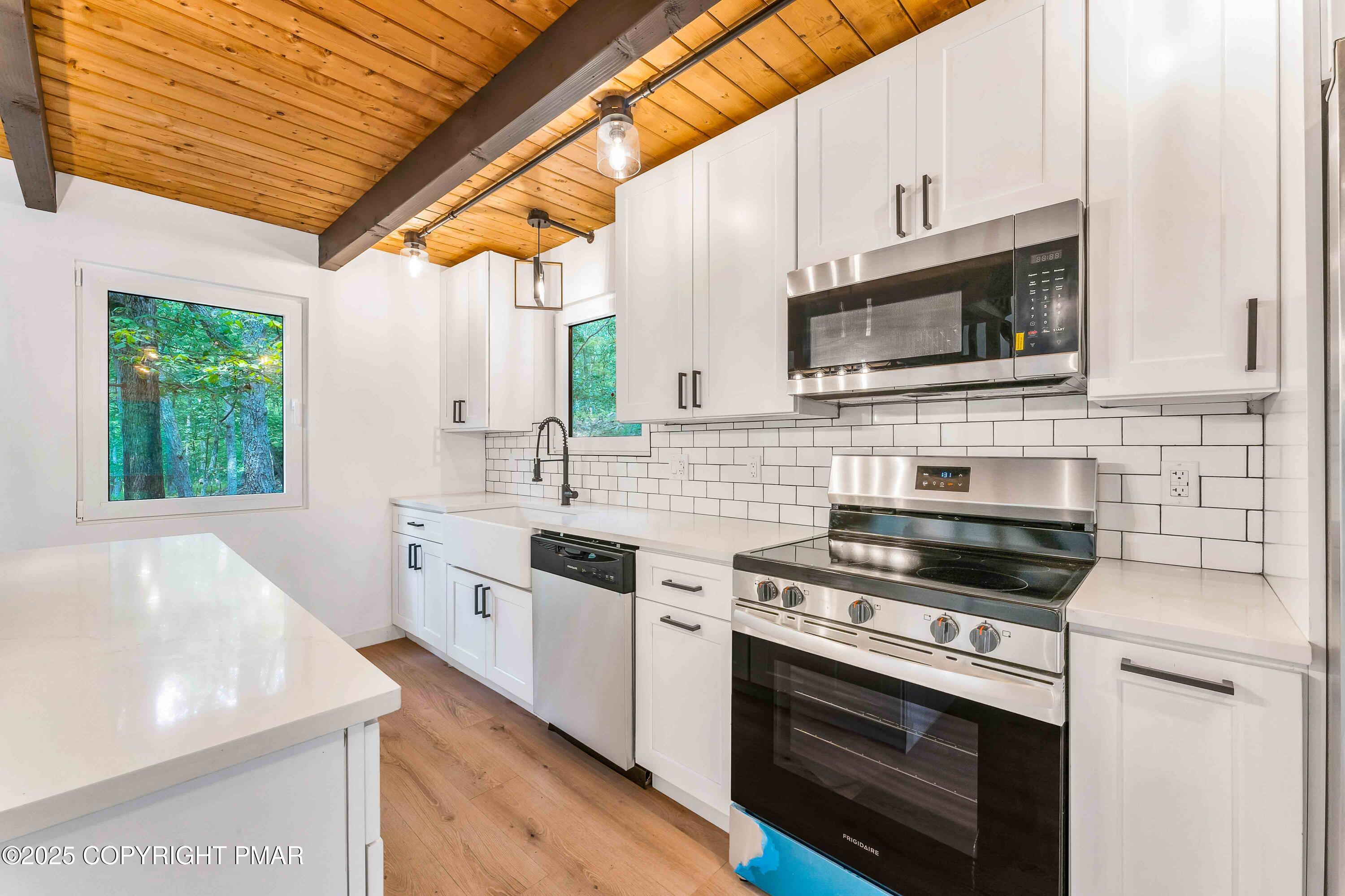 151 Elgin Way Bushkill, PA 18324 - Photo 4 of 60 a kitchen with stainless steel appliances a stove sink and microwave