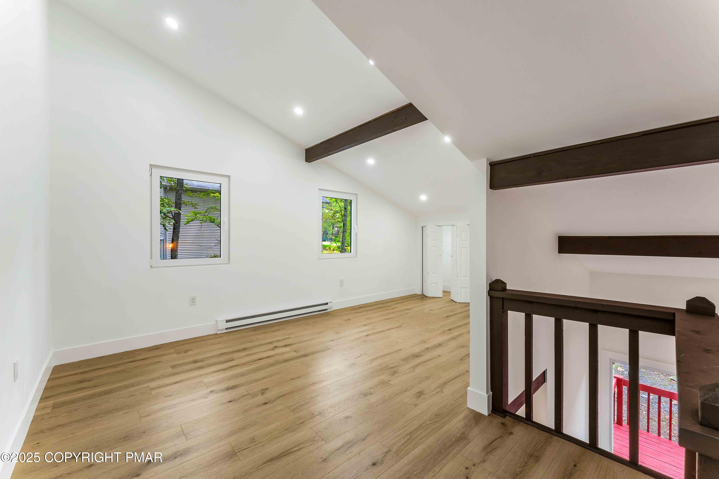 151 Elgin Way Bushkill, PA 18324 - Photo 43 of 60 a view of an empty room with wooden floor and a window