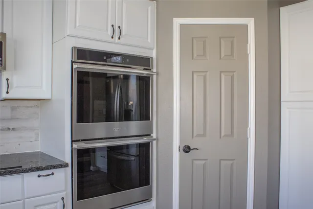 a stove top oven sitting inside of a kitchen