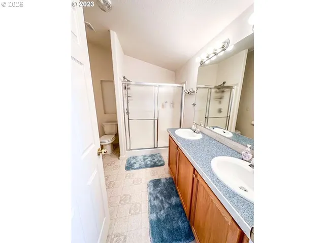 a bathroom with a granite countertop sink a mirror and a bathtub