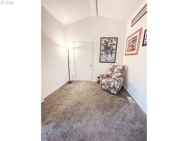 a bedroom with a bed and a painting