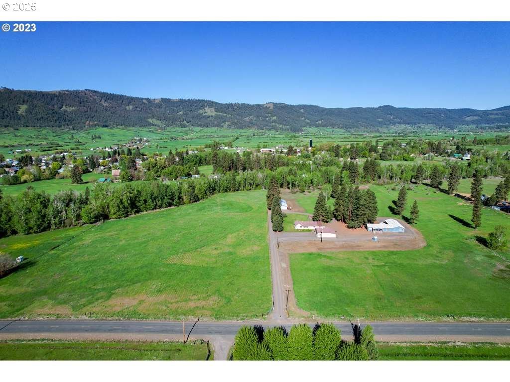46198 Slaughterhouse Road Halfway, OR 97834 - Photo 3 of 40 a view of a lush green hillside and a houses