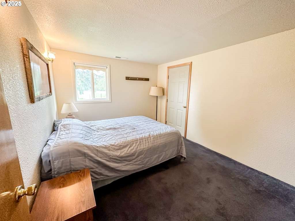 46198 Slaughterhouse Road Halfway, OR 97834 - Photo 31 of 40 a bedroom with a bed and a window