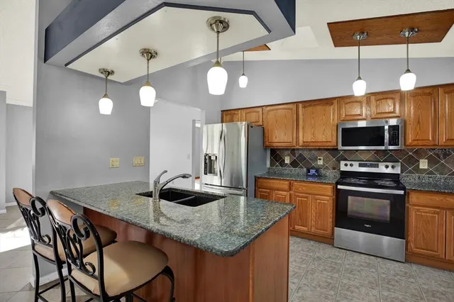 a kitchen with stainless steel appliances granite countertop a stove and a sink