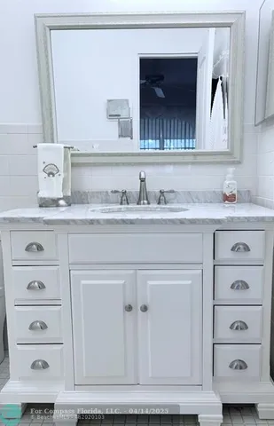 a bathroom with a granite countertop toilet sink and a mirror