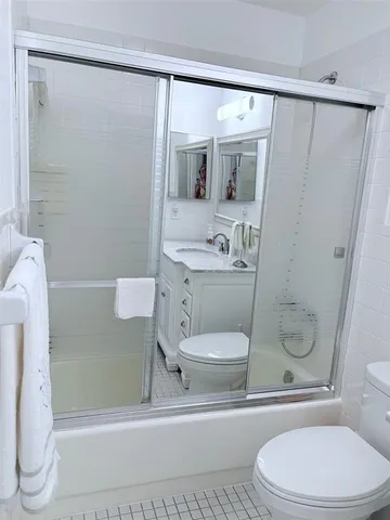 a white toilet sitting next to a bathroom sink