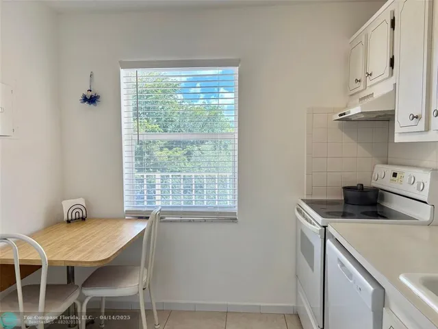 a view of a dining room with furniture a chandelier and wooden floor