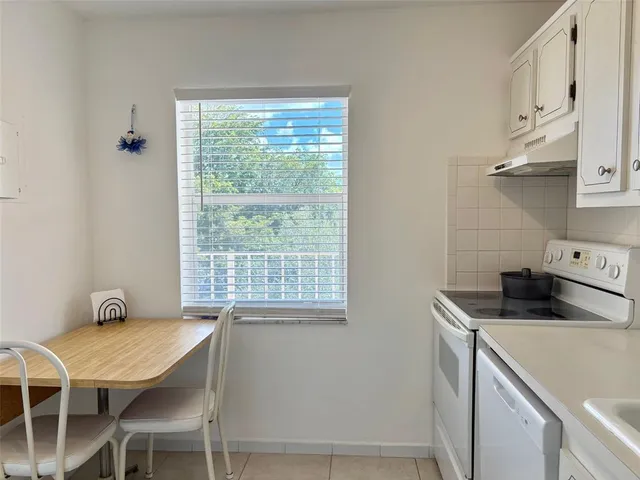 a kitchen that has a cabinets and a table in it