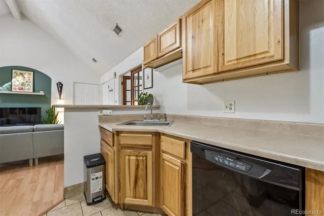 a kitchen with granite countertop cabinets stainless steel appliances and a counter space