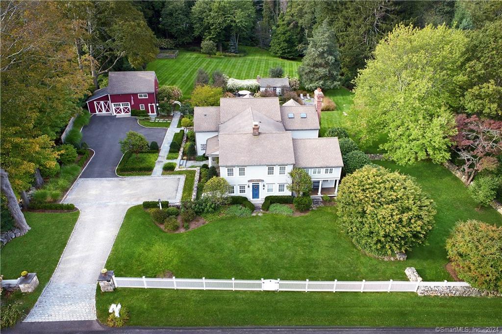 an aerial view of a house with garden space and street view