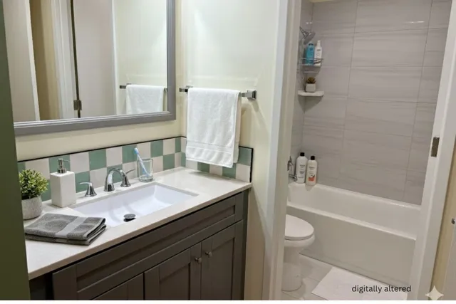a bathroom with a granite countertop sink and a mirror a bathtub