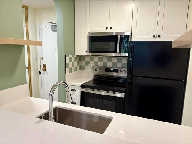 a kitchen with a sink and a refrigerator