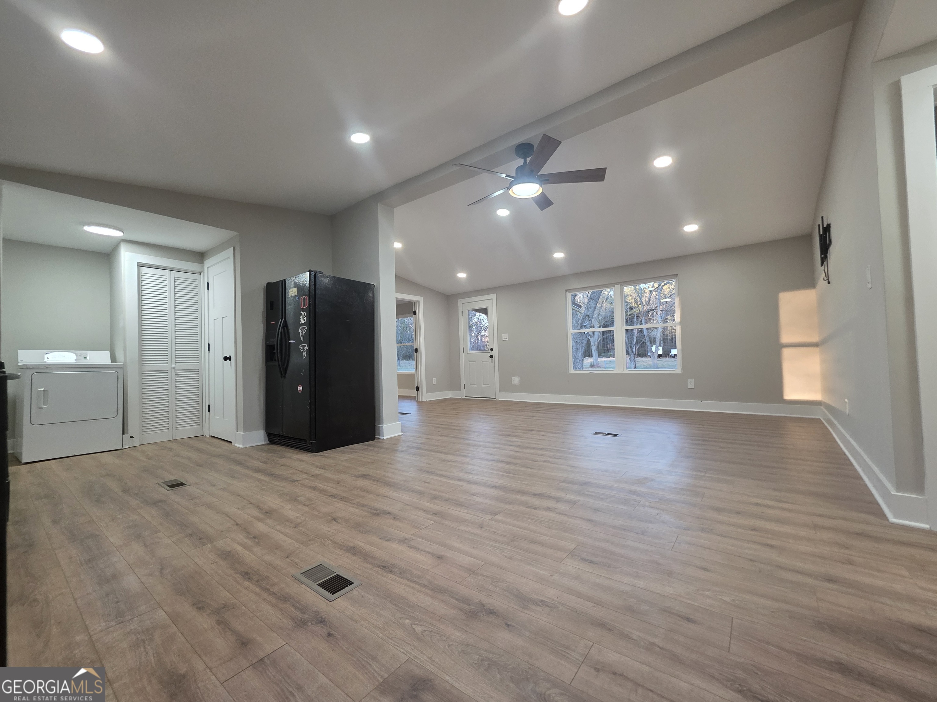 115 Little Street Williamson, GA 30292 - Photo 5 of 9 a view of an empty room with a window and wooden floor