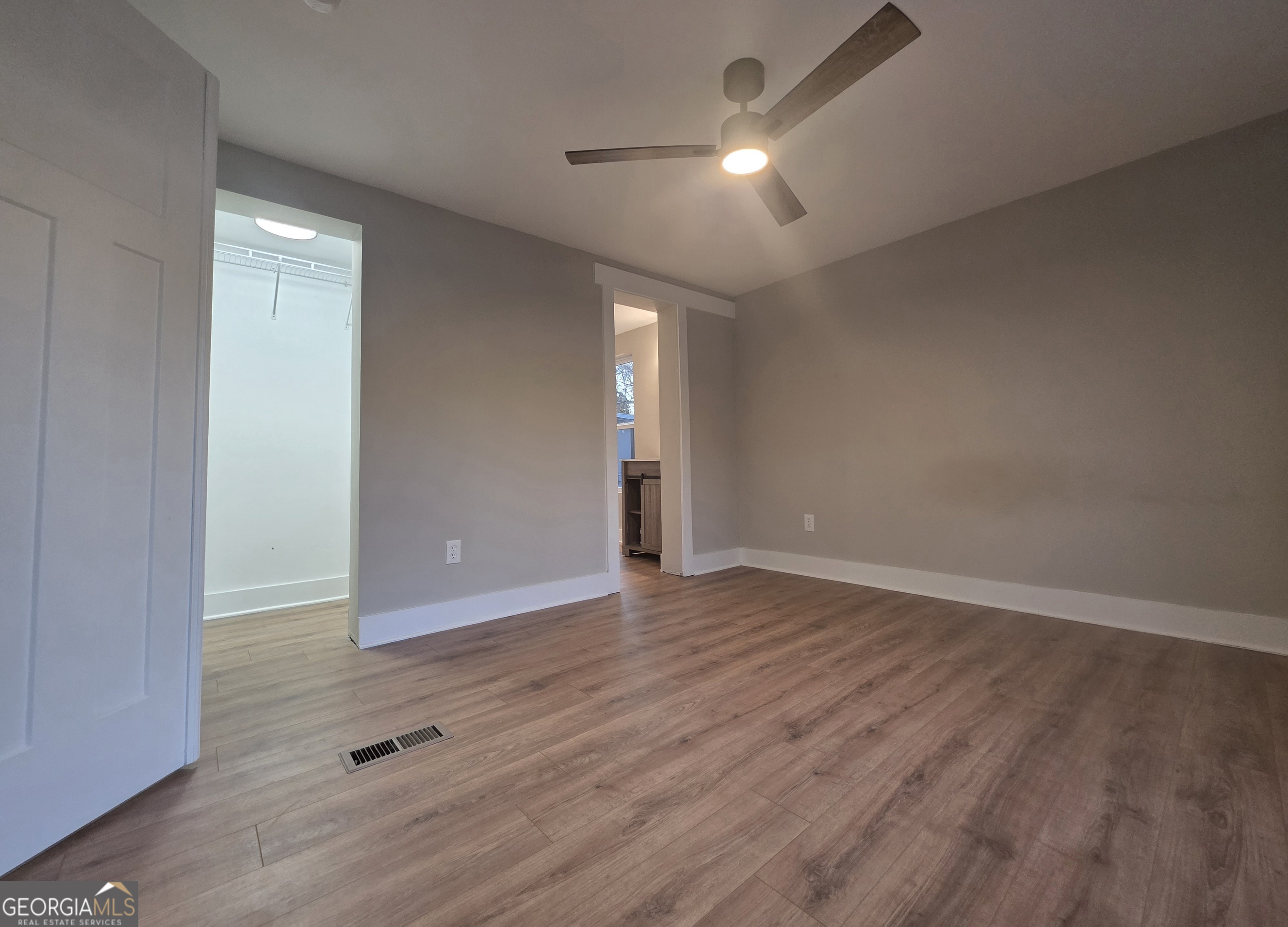 115 Little Street Williamson, GA 30292 - Photo 9 of 9 an empty room with wooden floor and windows
