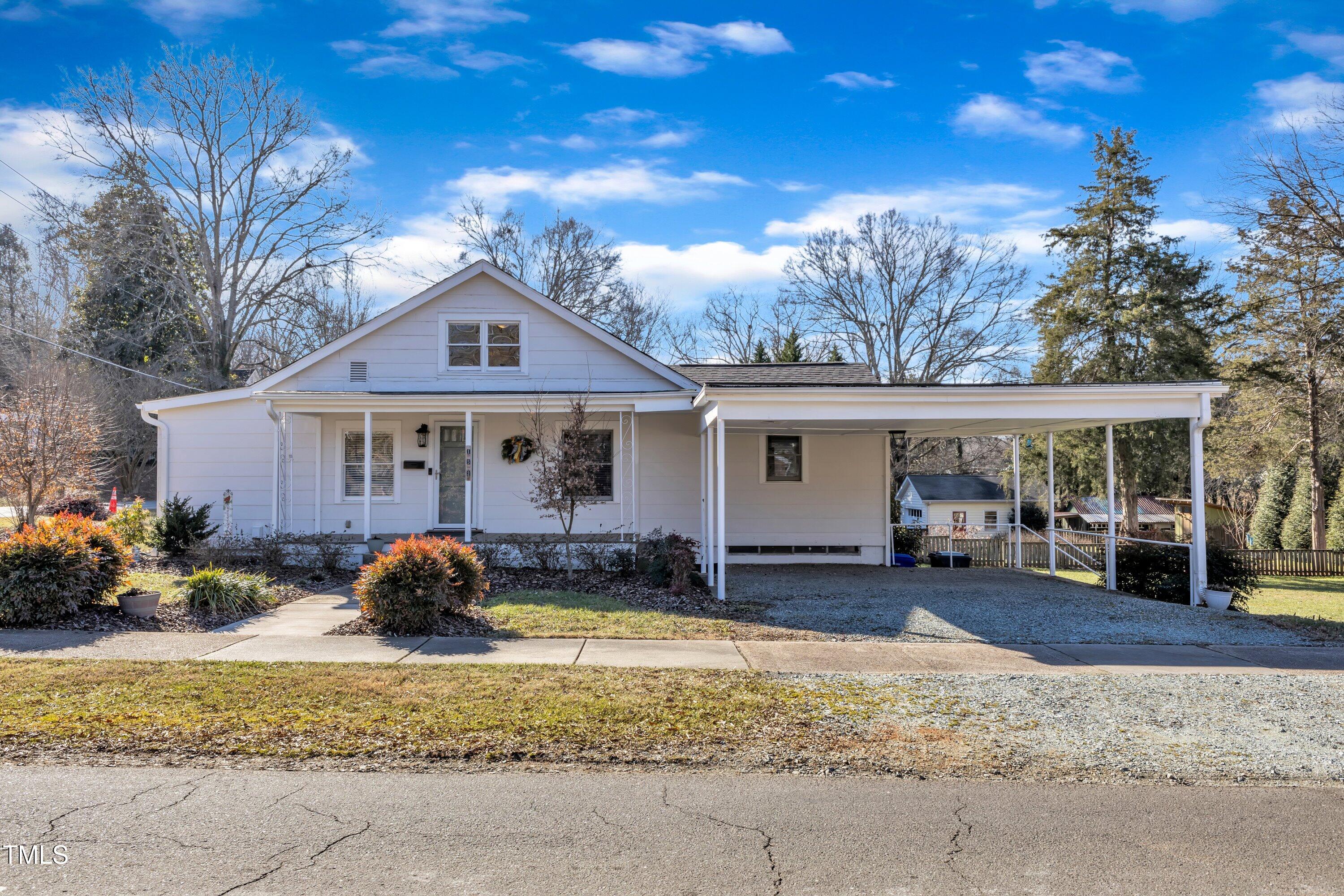 a front view of a house with a yard and outdoor seating