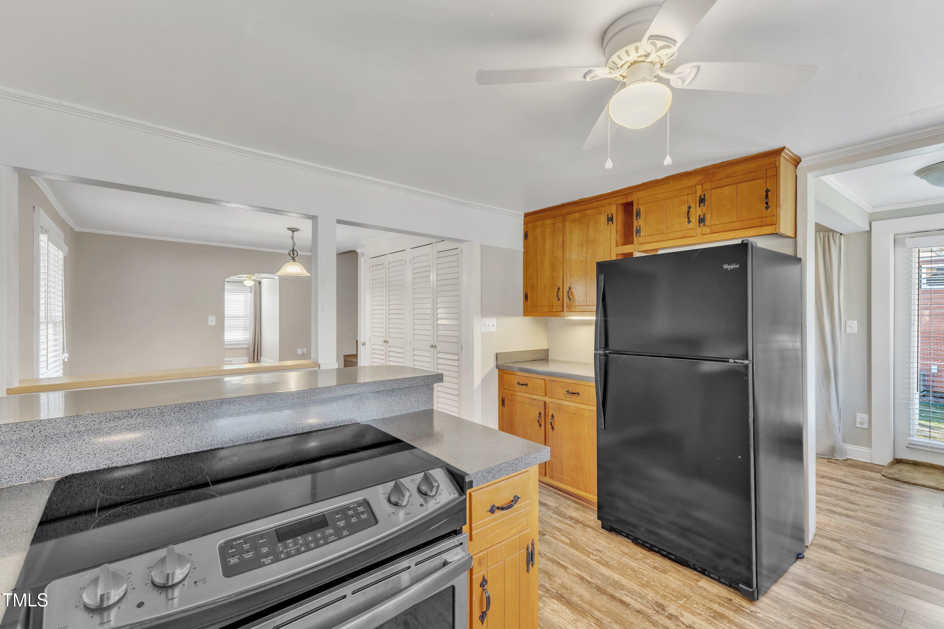 152 East Tryon Street Hillsborough, NC 27278 - Photo 11 of 34 a kitchen with a stove a refrigerator and a fireplace