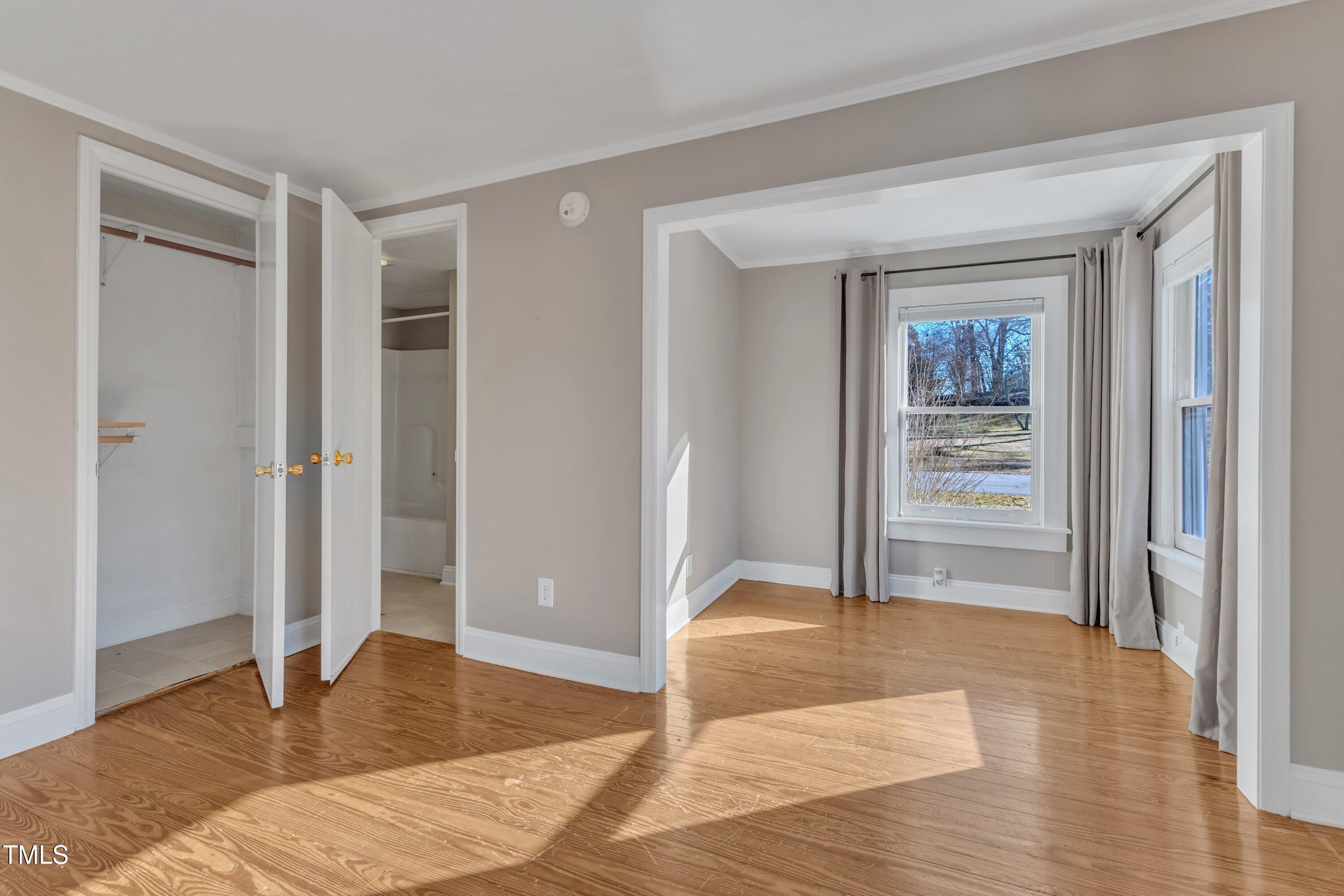 152 East Tryon Street Hillsborough, NC 27278 - Photo 15 of 34 a bedroom with a bed and wooden floor