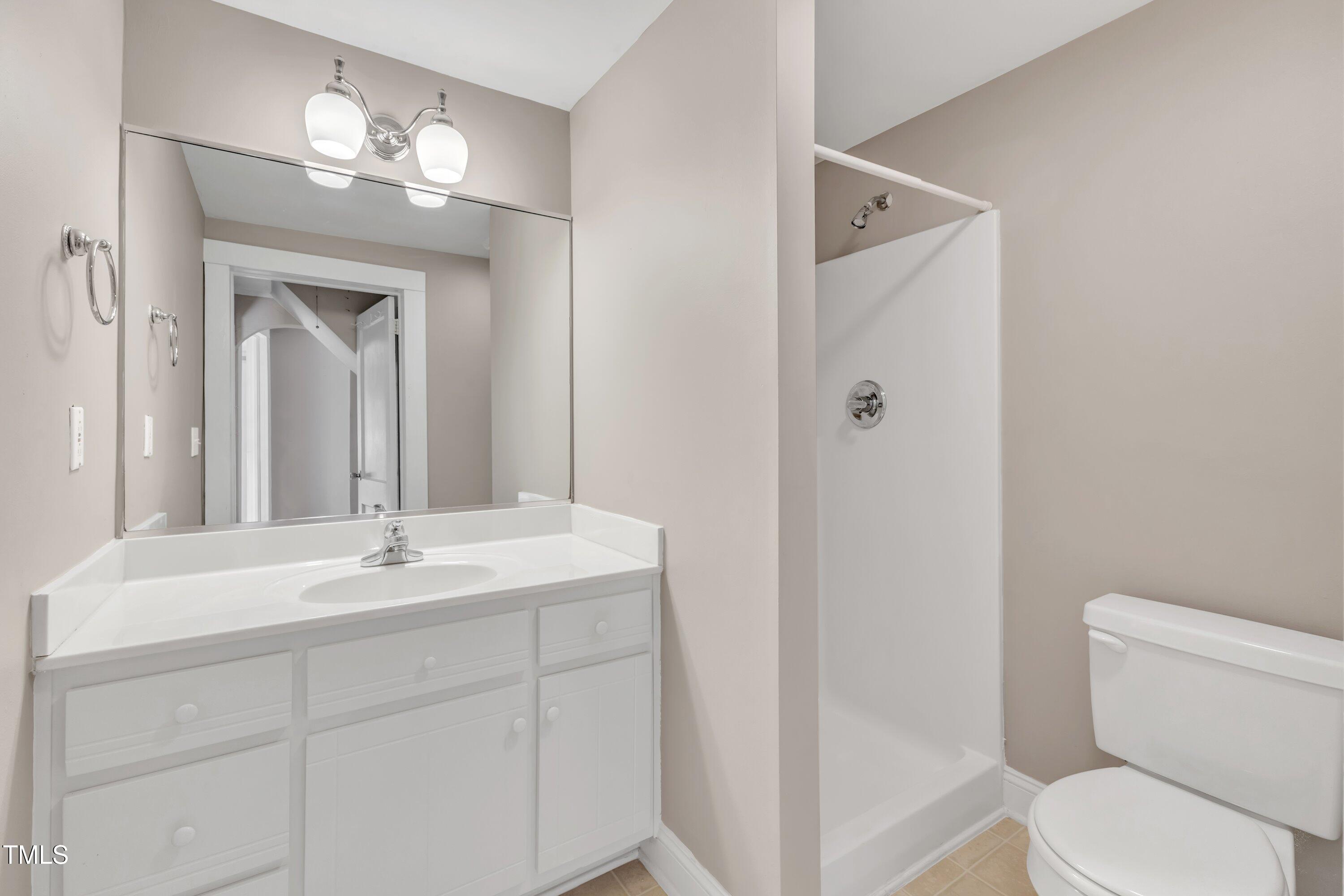 152 East Tryon Street Hillsborough, NC 27278 - Photo 23 of 34 a bathroom with a toilet a sink and mirror