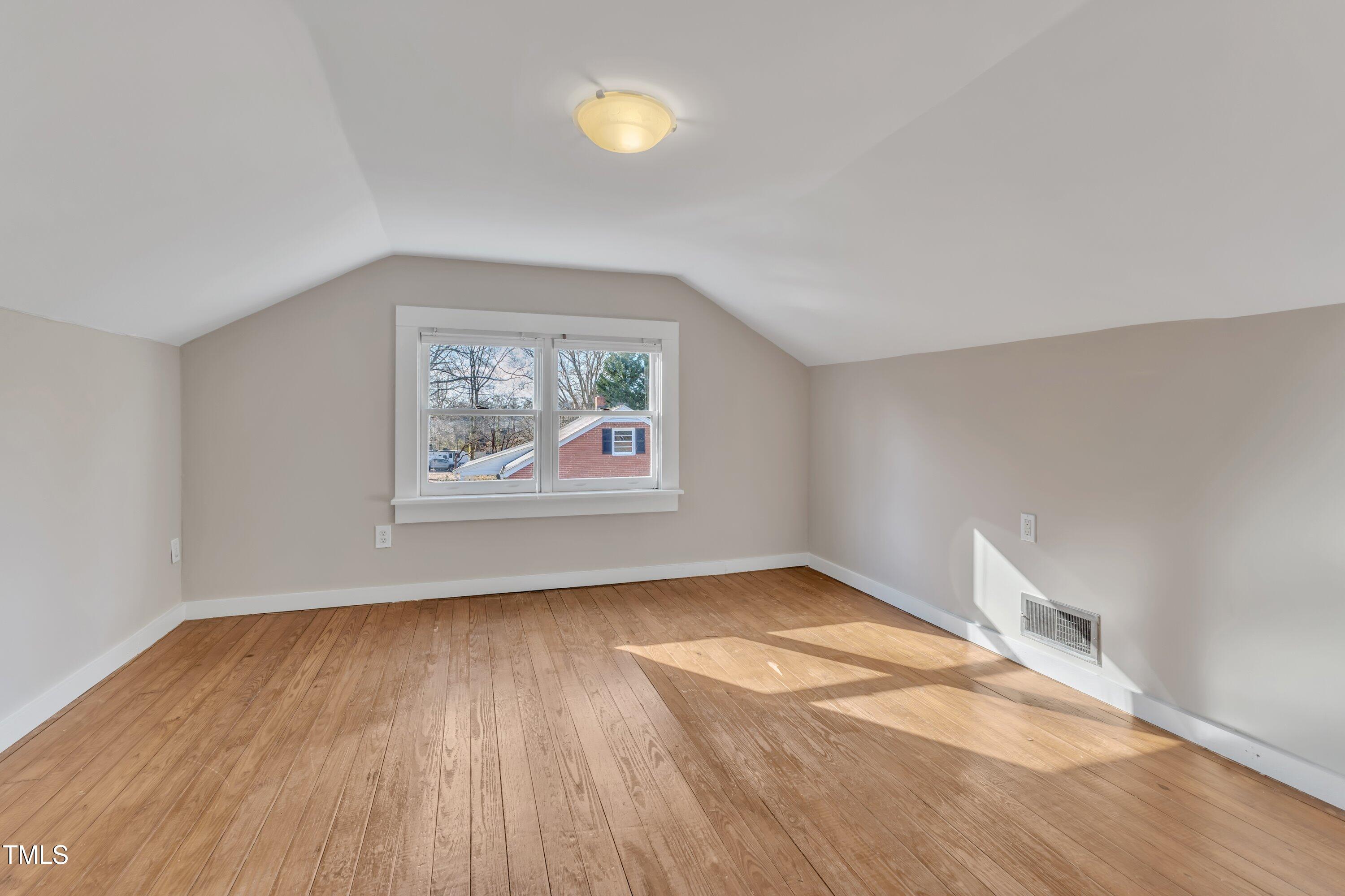 152 East Tryon Street Hillsborough, NC 27278 - Photo 27 of 34 an empty room with wooden floor and windows
