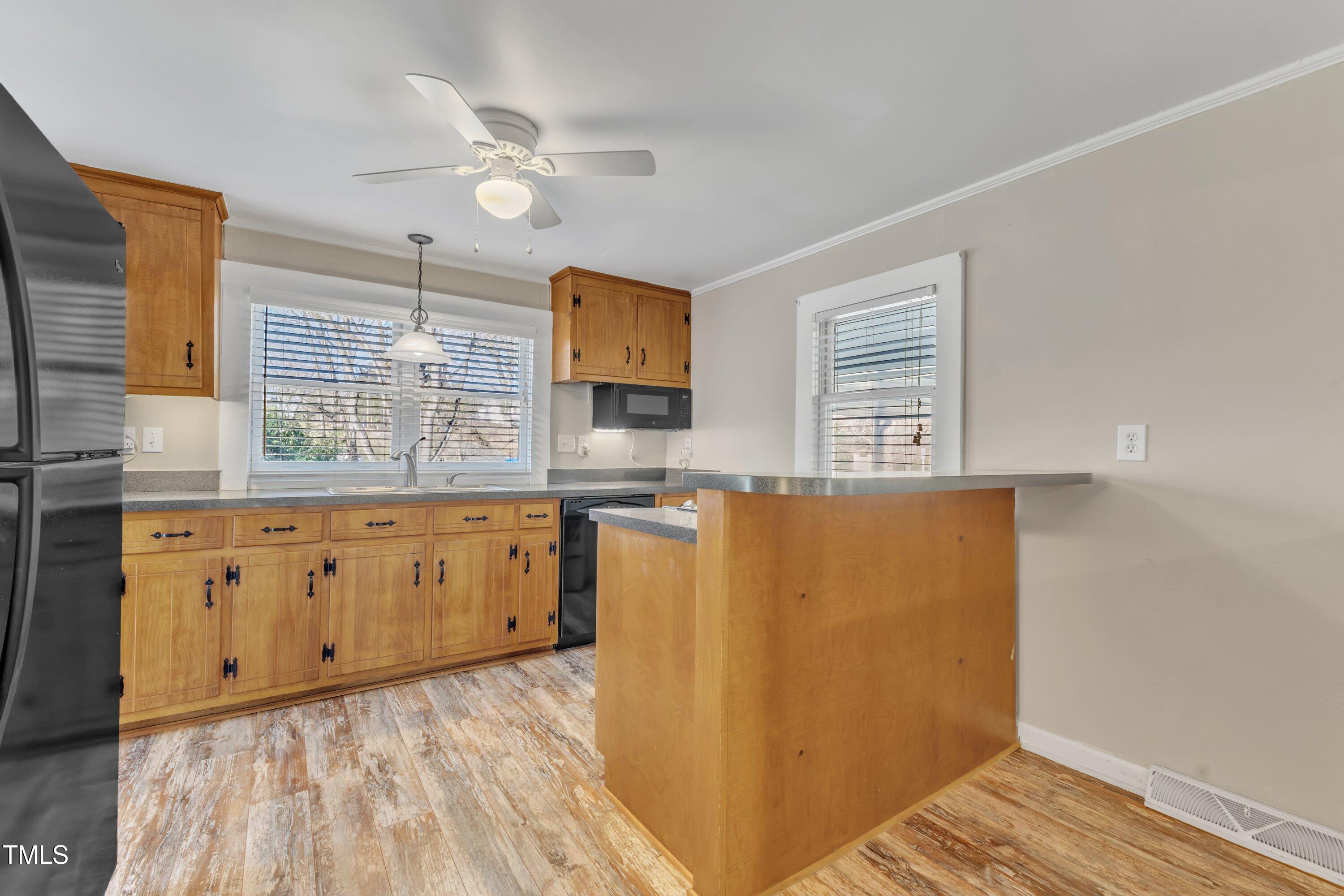 152 East Tryon Street Hillsborough, NC 27278 - Photo 9 of 34 a kitchen with cabinets a sink and wooden floor