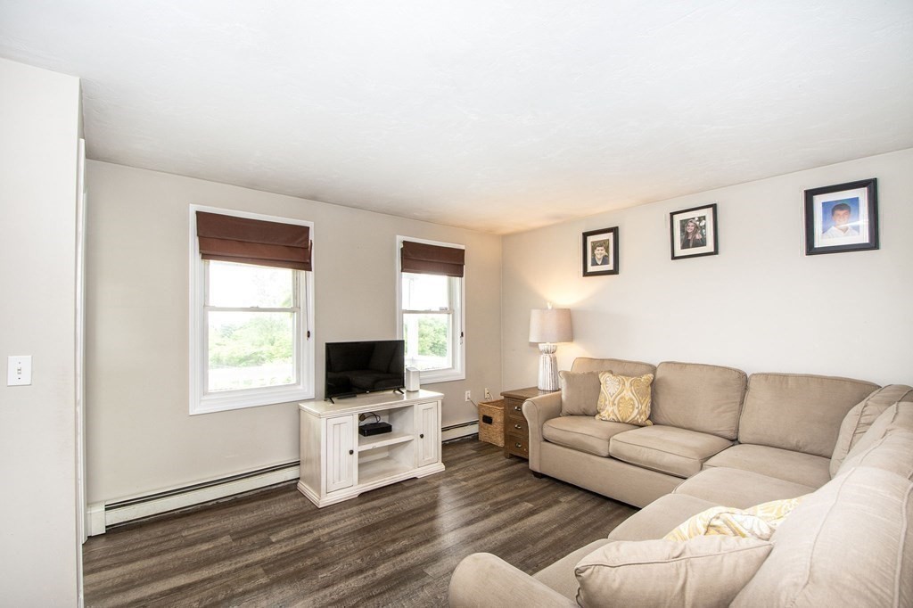 3 Battery Road Hull, MA 02045 - Photo 17 of 42 a living room with furniture a flat screen tv and a window