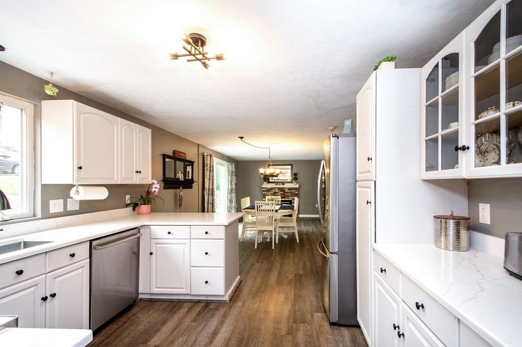 3 Battery Road Hull, MA 02045 - Photo 4 of 42 a open kitchen with white cabinets and wooden floor