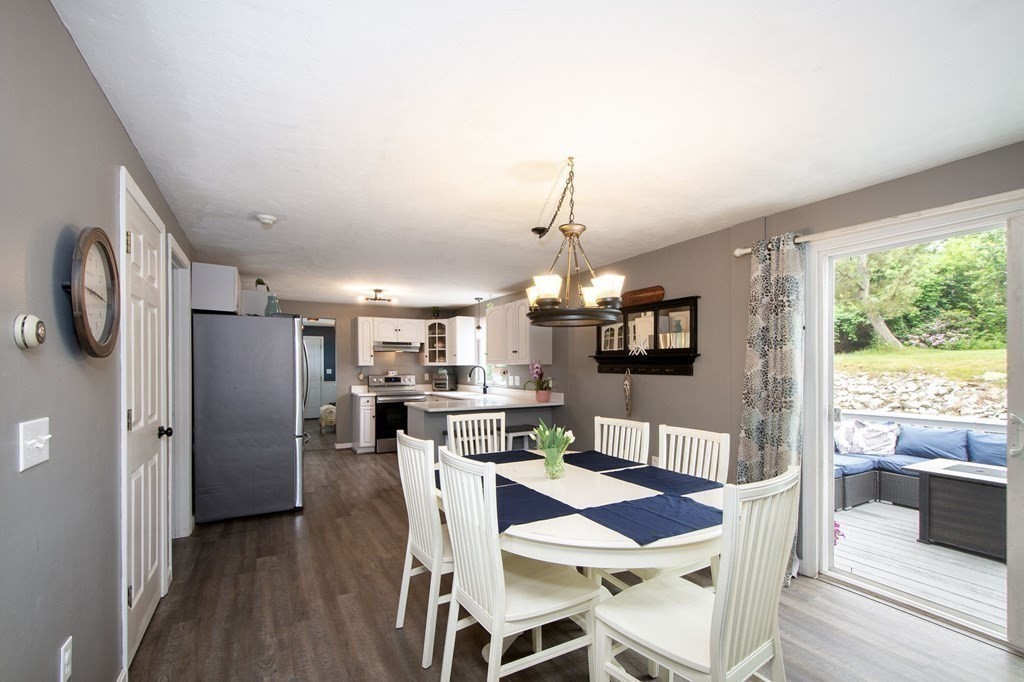 3 Battery Road Hull, MA 02045 - Photo 7 of 42 a view of a dining room with furniture a chandelier and wooden floor