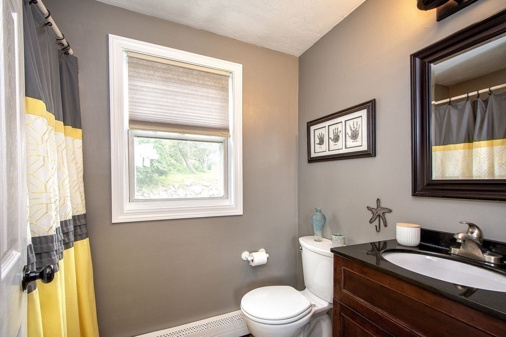 3 Battery Road Hull, MA 02045 - Photo 10 of 42 a bathroom with a granite countertop toilet sink and mirror