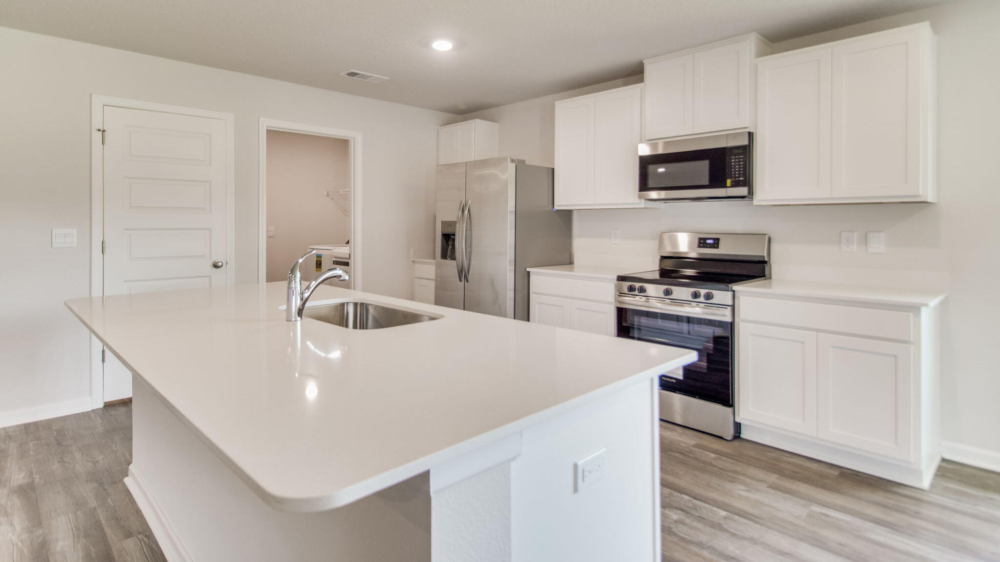 5614 Thatcher Road Crestview, FL 32539 - Photo 5 of 30 a kitchen with stainless steel appliances a microwave a stove a sink and a refrigerator