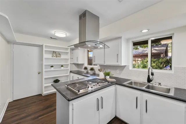 a kitchen with stainless steel appliances a sink stove and refrigerator