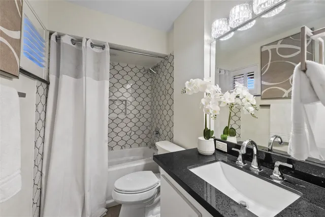 a bed room with a bed and a chandelier