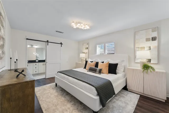 a bathroom with a granite countertop sink a mirror and a shower