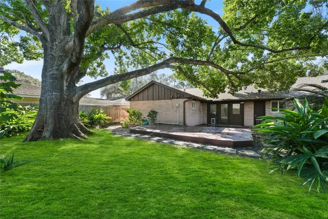 a backyard of a house with table and chairs