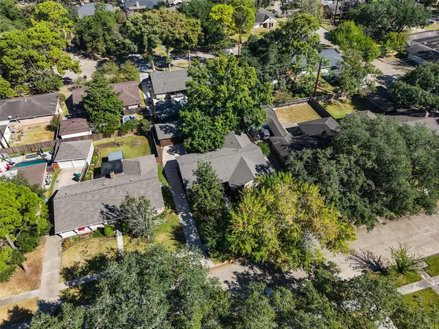 an aerial view of a house with a yard basket ball court and outdoor seating