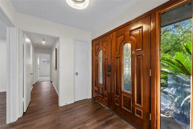 a view of a entryway door with wooden floor