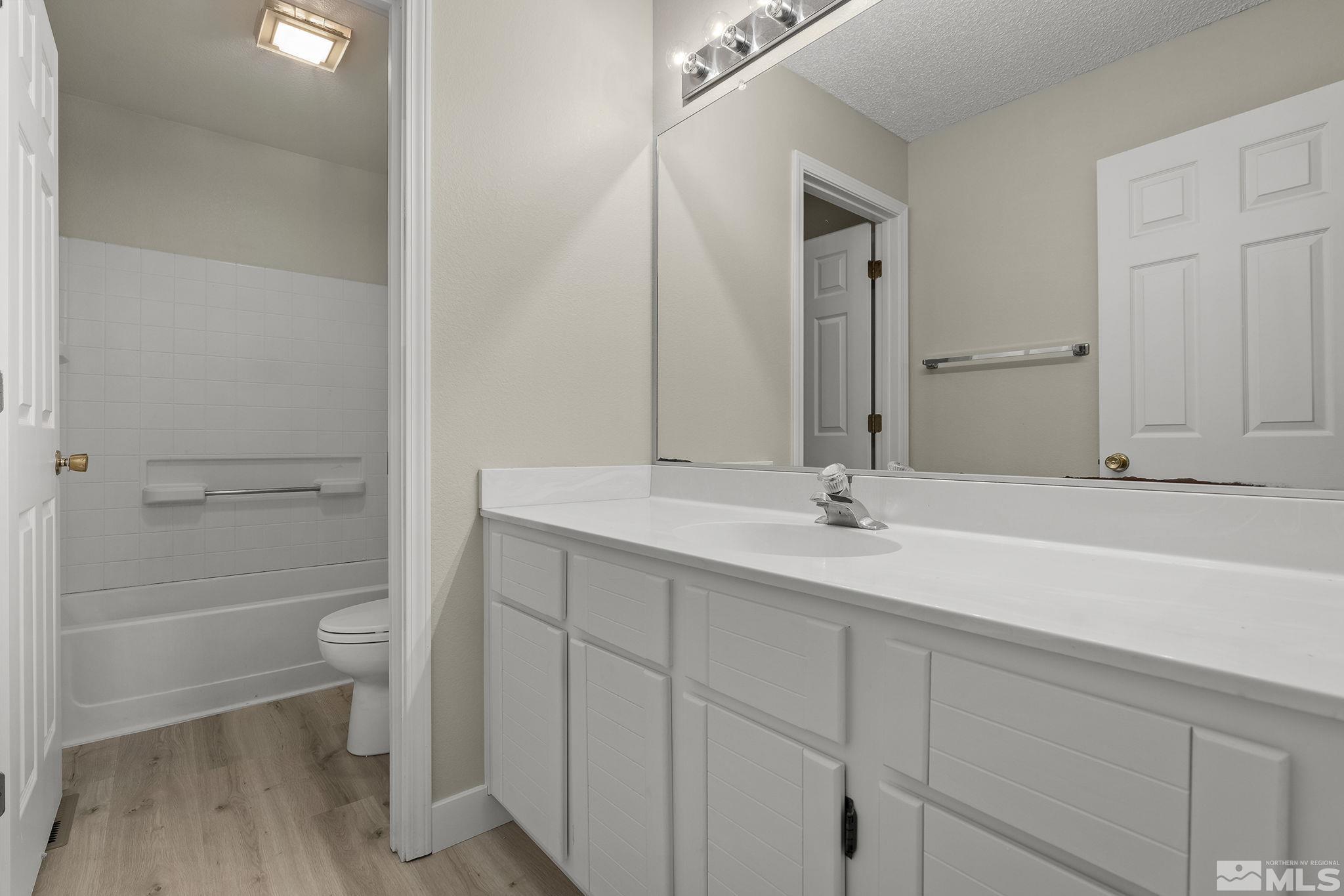 5267 Simons Drive Reno, NV 89523 - Photo 22 of 33 a bathroom with a double vanity sink and a toilet