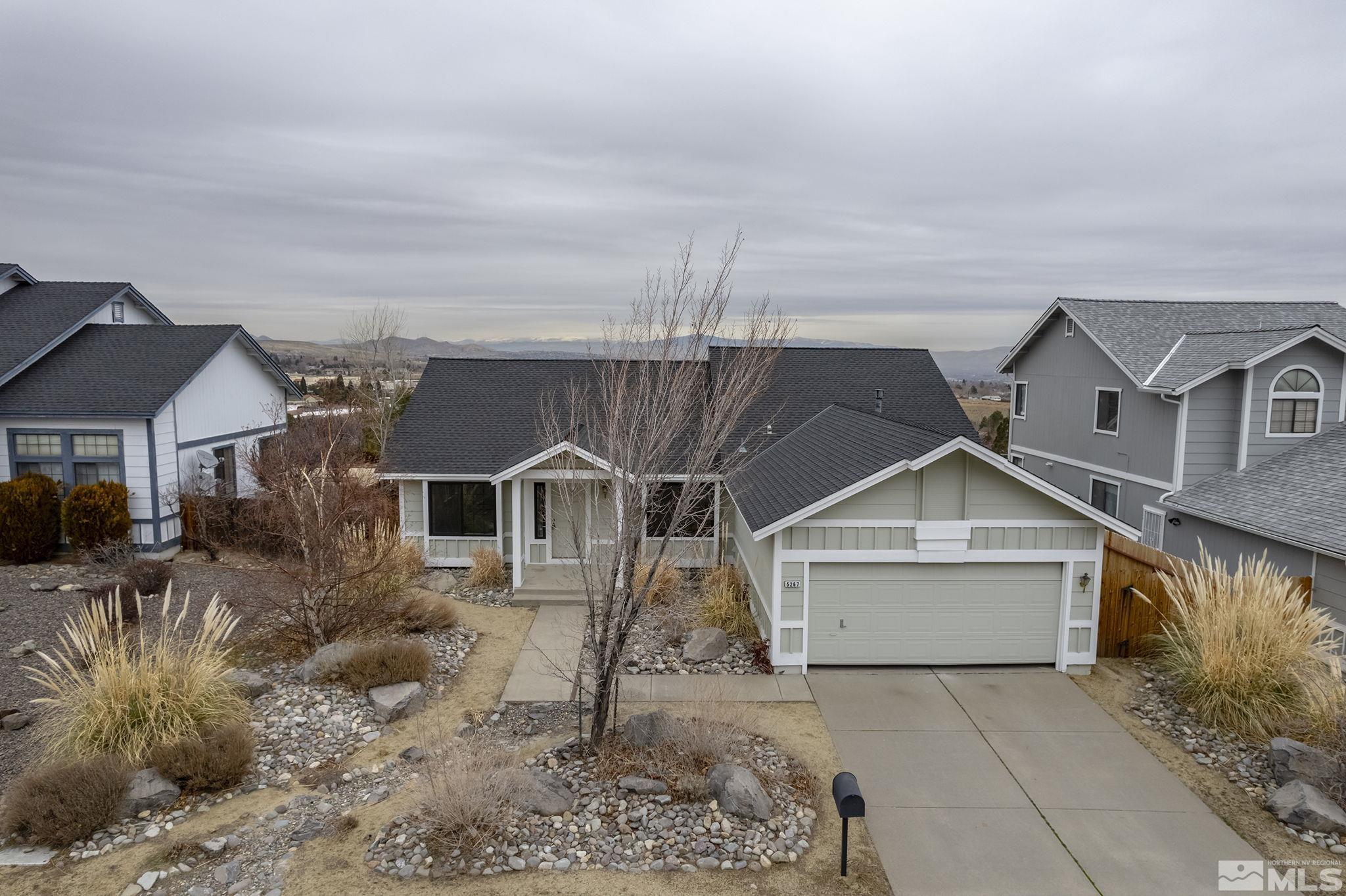 5267 Simons Drive Reno, NV 89523 - Photo 26 of 33 a front view of a house with a yard and garage
