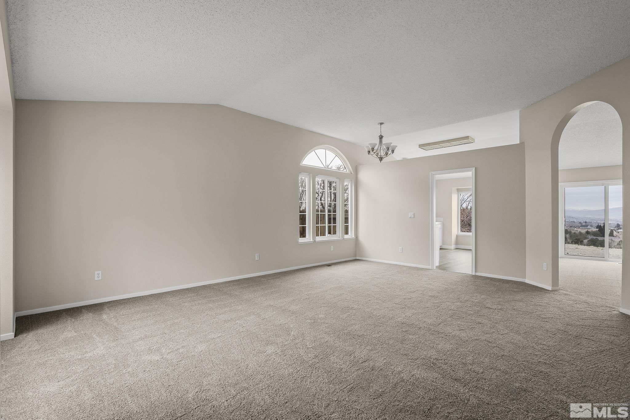5267 Simons Drive Reno, NV 89523 - Photo 4 of 33 a view of a big room with windows and chandelier