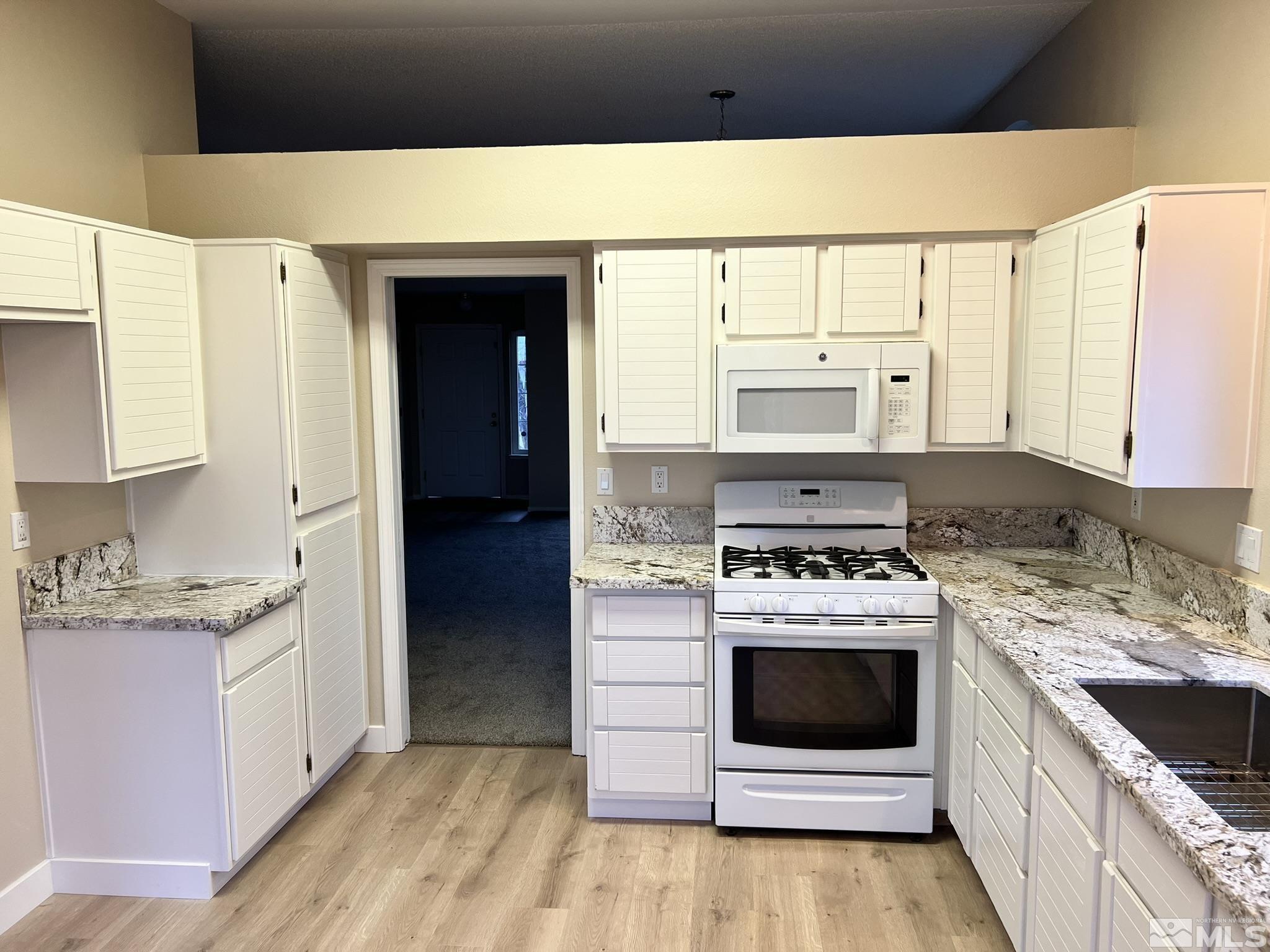 5267 Simons Drive Reno, NV 89523 - Photo 7 of 33 a kitchen with a stove and a sink
