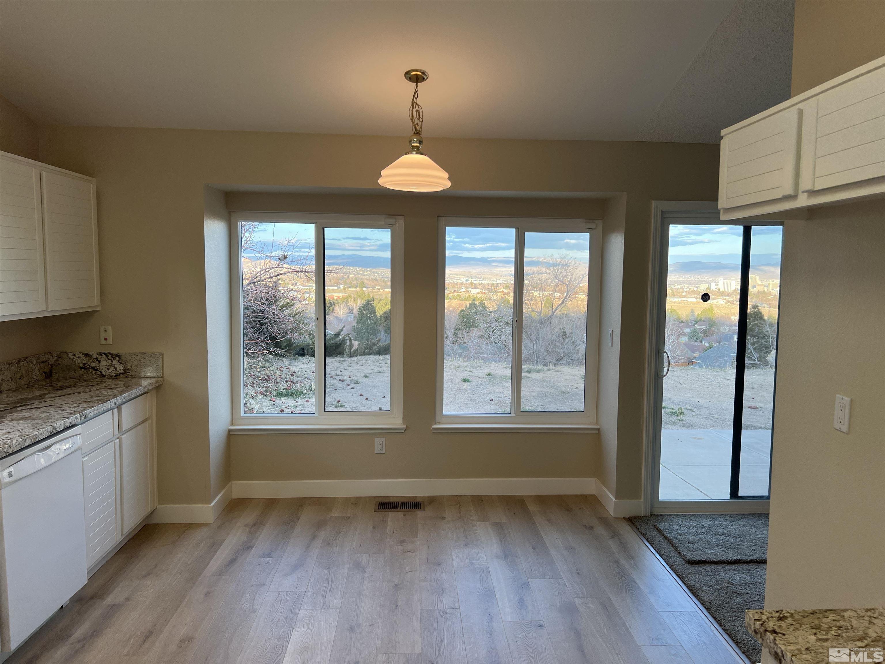 5267 Simons Drive Reno, NV 89523 - Photo 8 of 33 a view of an empty room with a window and wooden floor