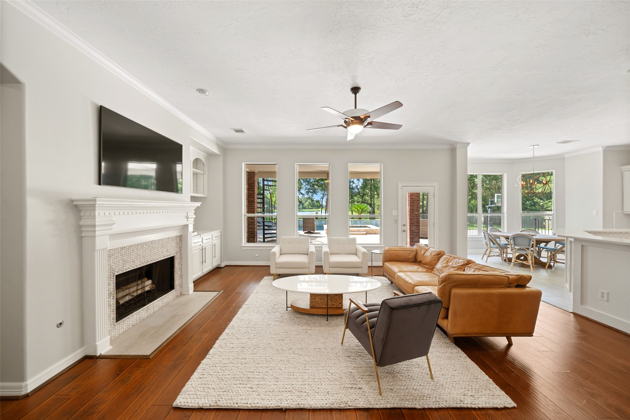 2302 Legends Shore Drive Spring, TX 77386 - Photo 12 of 48 Inviting living room centered around a beautiful fireplace and framed by scenic backyard views.
