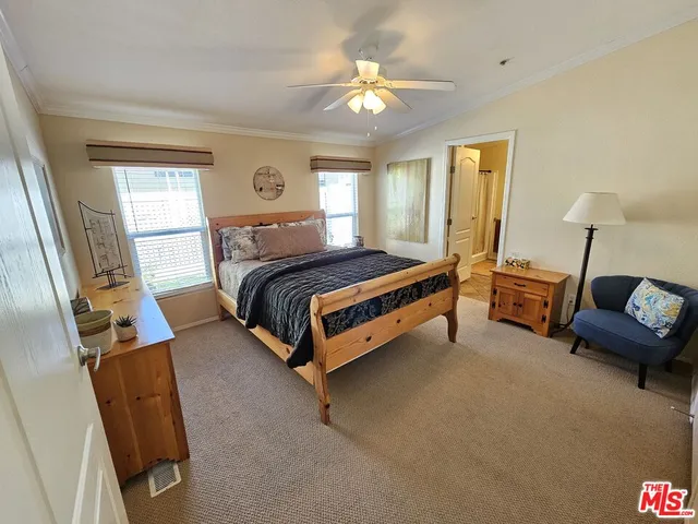 a bedroom with a bed couch and a window