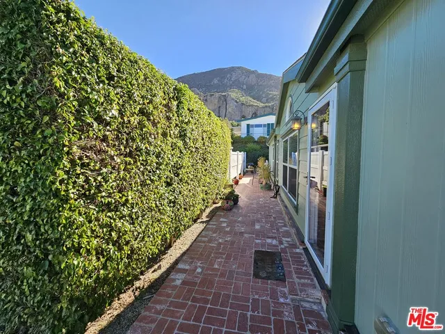 a view of a pathway both side of a house