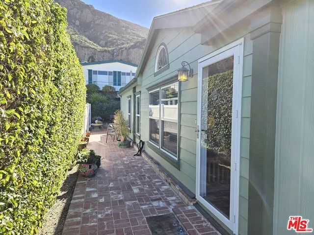 a view of a pathway both side of the house