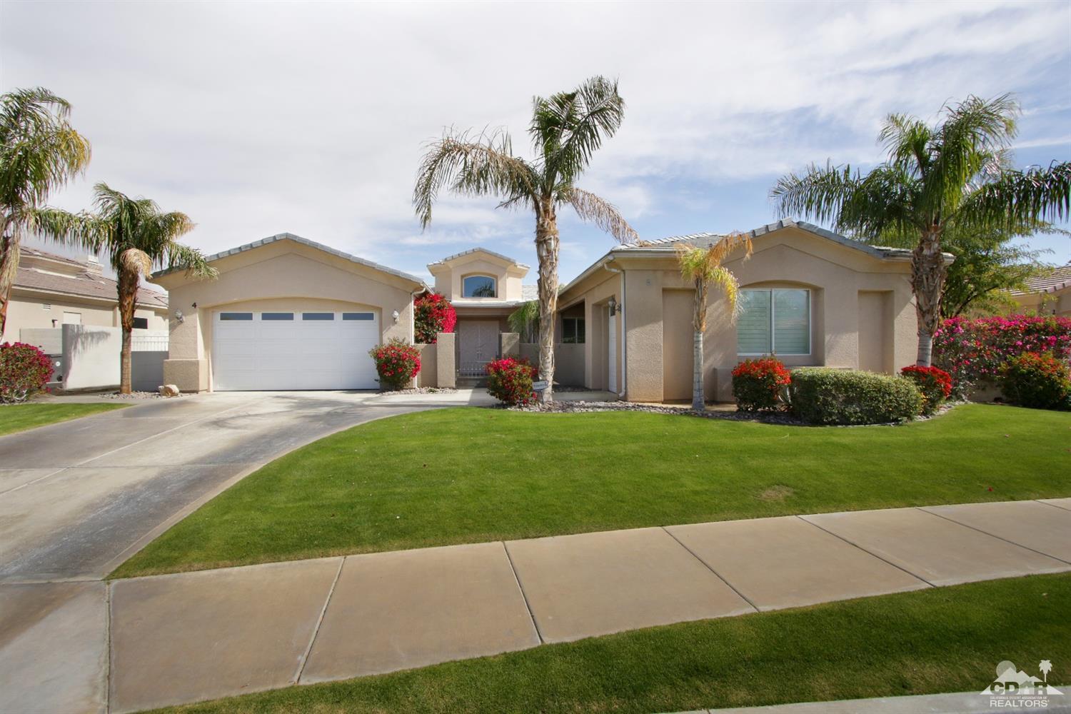 4 Orleans Road Rancho Mirage, CA 92270 - Photo 2 of 35 a front view of a house with a garden and yard