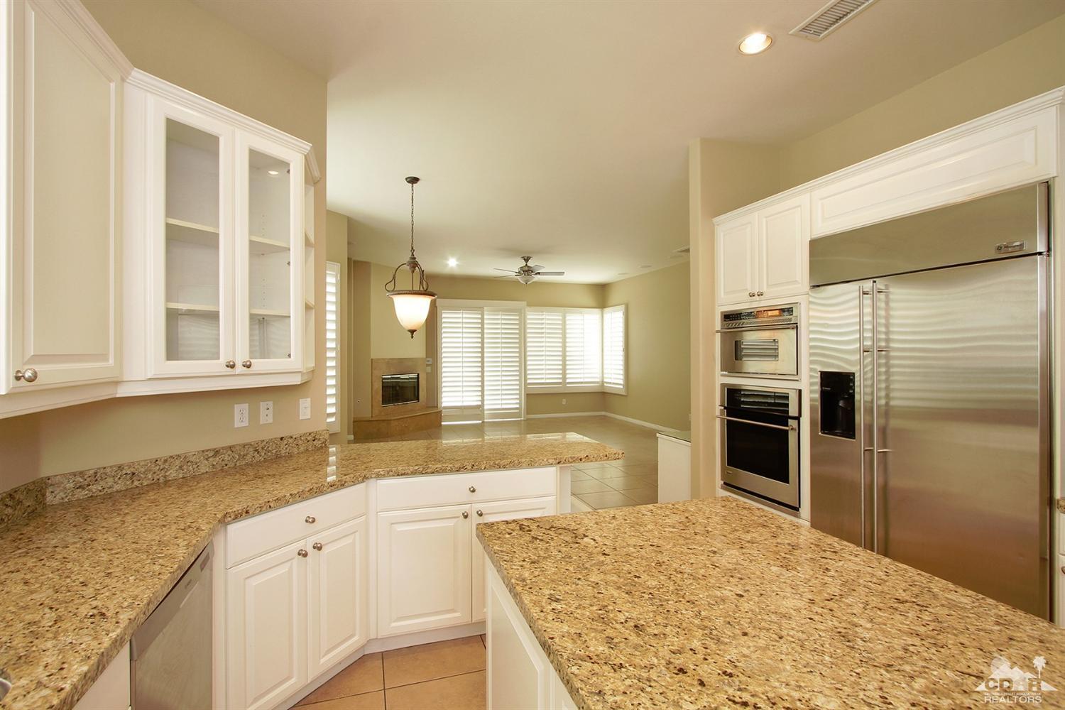 4 Orleans Road Rancho Mirage, CA 92270 - Photo 16 of 35 a large kitchen with granite countertop a refrigerator and a sink