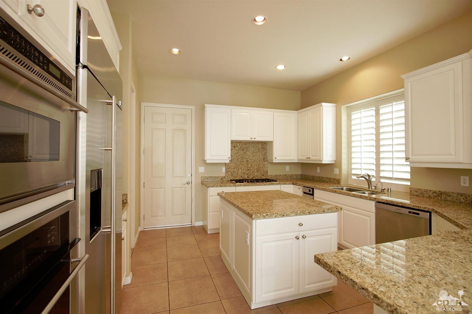 4 Orleans Road Rancho Mirage, CA 92270 - Photo 17 of 35 a kitchen with a stove sink and refrigerator