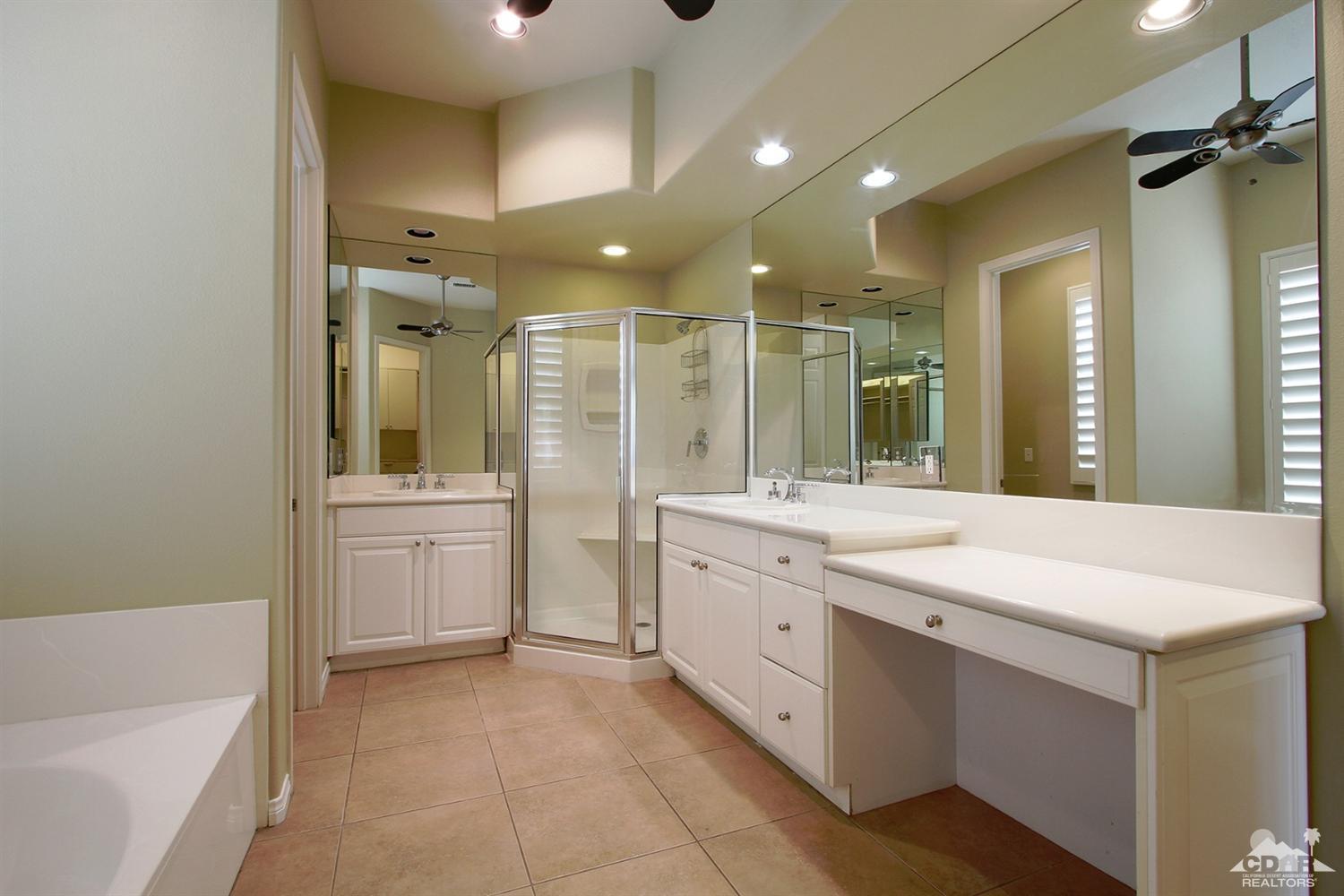 4 Orleans Road Rancho Mirage, CA 92270 - Photo 20 of 35 a bathroom with a sink a large mirror and a bathtub