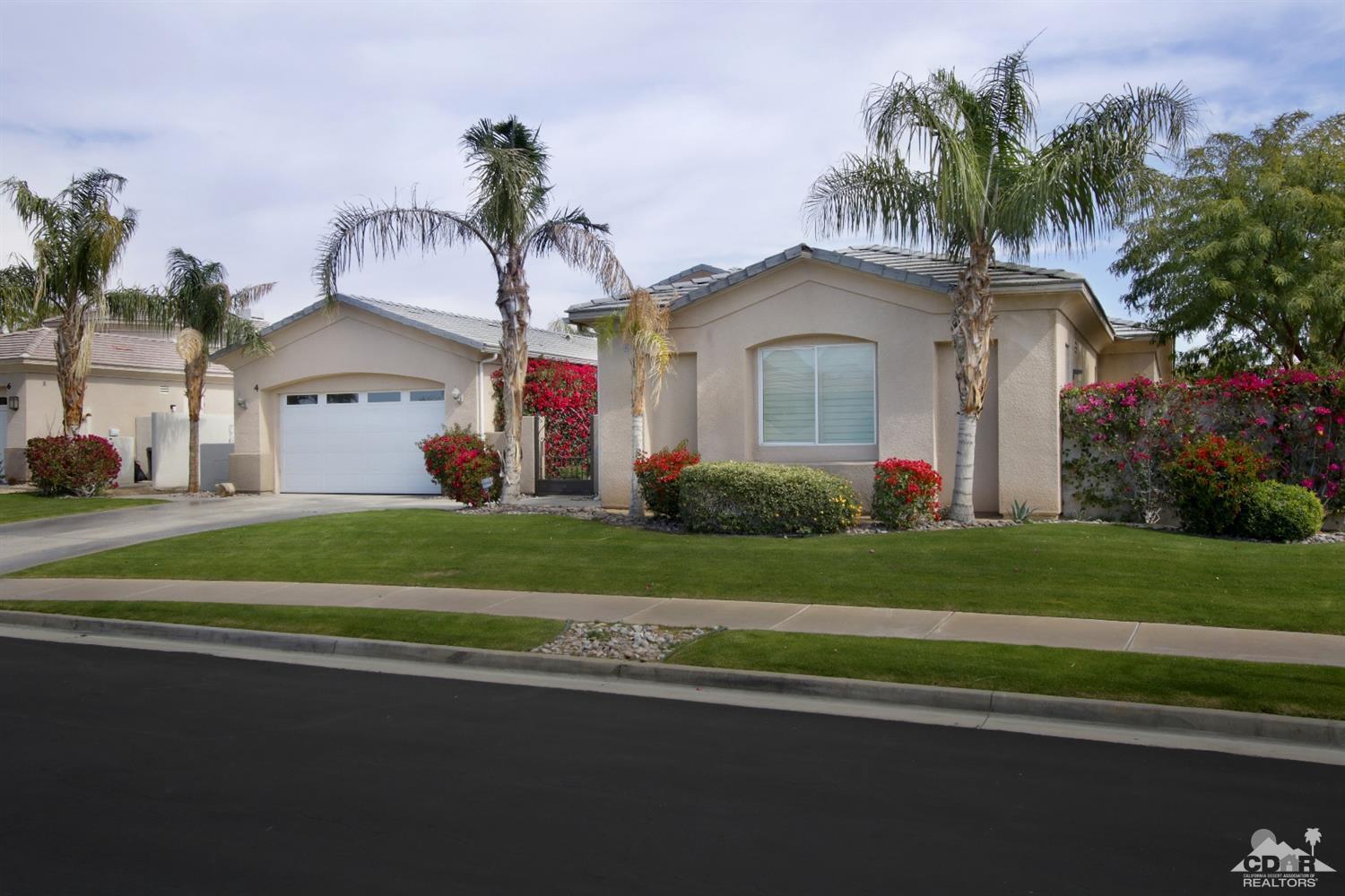 4 Orleans Road Rancho Mirage, CA 92270 - Photo 3 of 35 a front view of a house with a garden and plants
