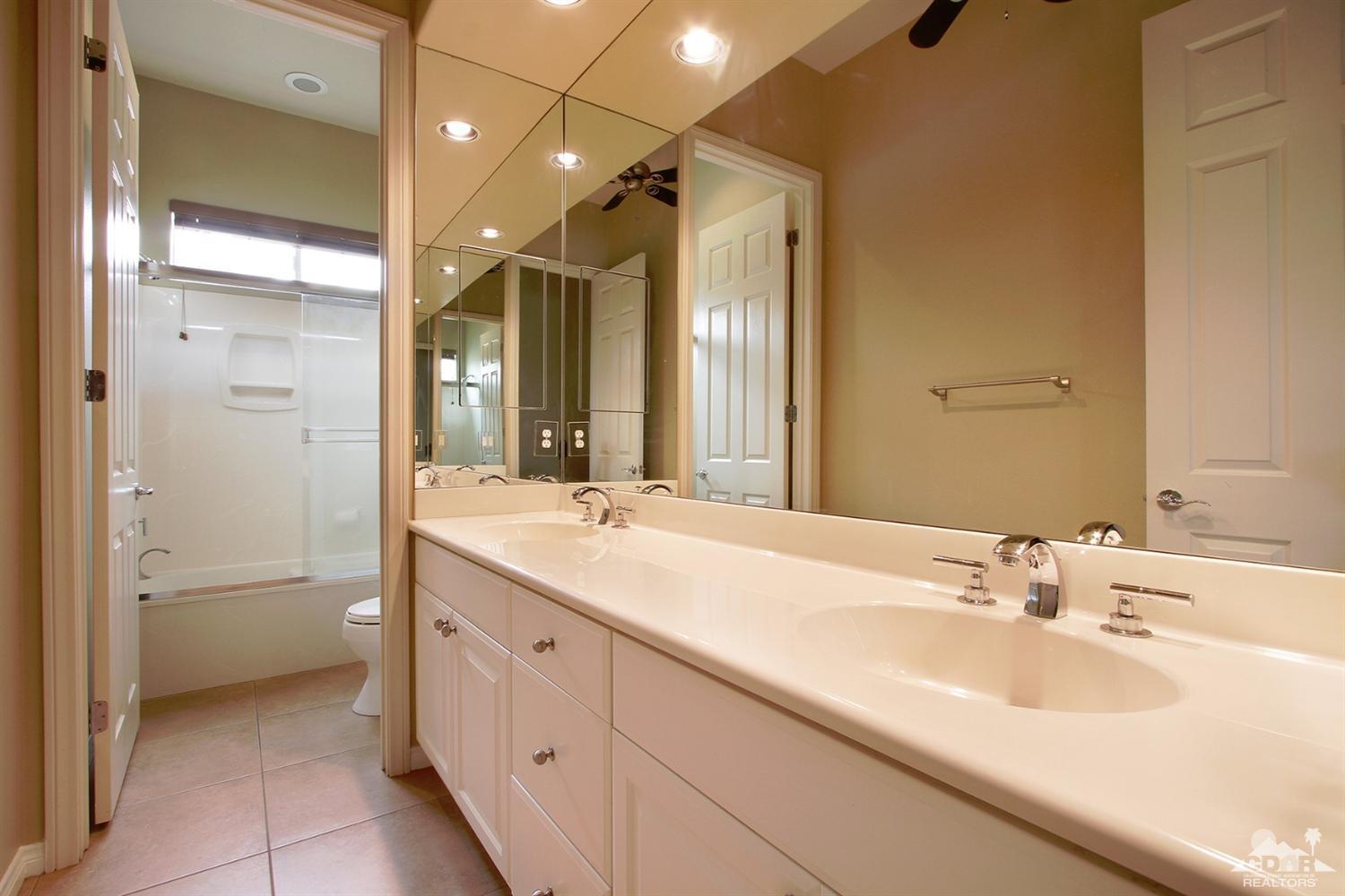 4 Orleans Road Rancho Mirage, CA 92270 - Photo 27 of 35 a bathroom with a sink and a mirror